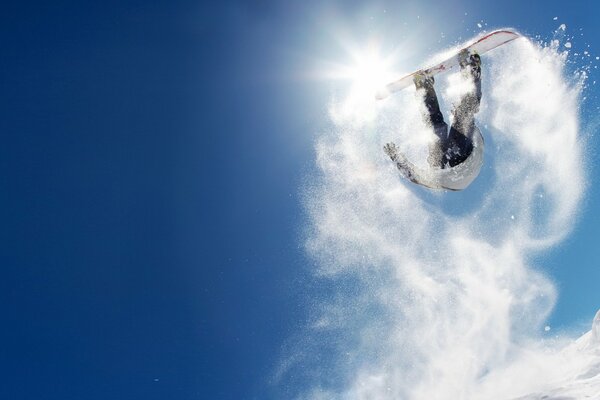 Sauter les snowboarders dans les montagnes enneigées