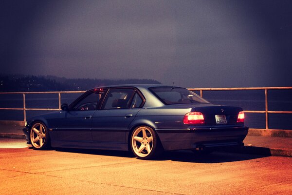 Tuned BMW e38 on the embankment