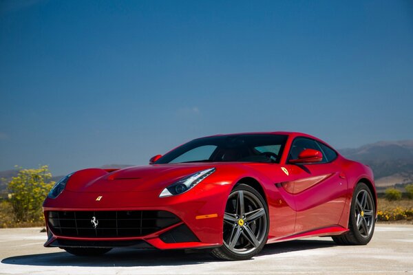 On the background of the sky - a powerful red Ferrari