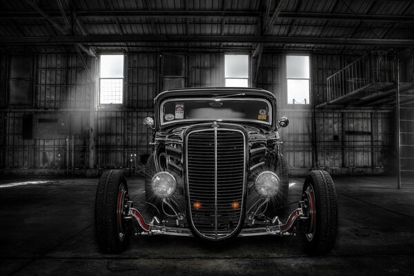 Old classic car in a hangar front view