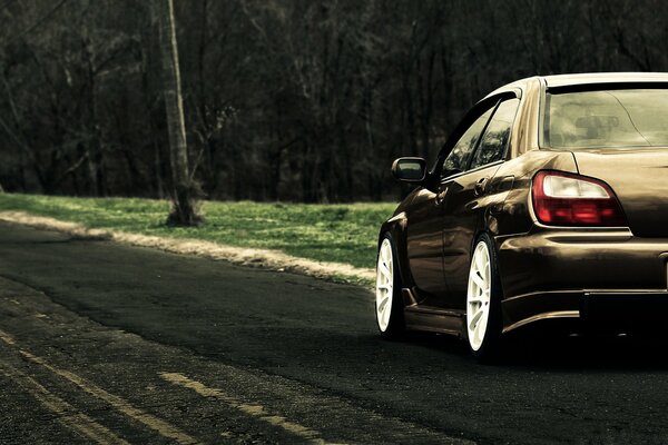 The movement of a brown car on a forest road