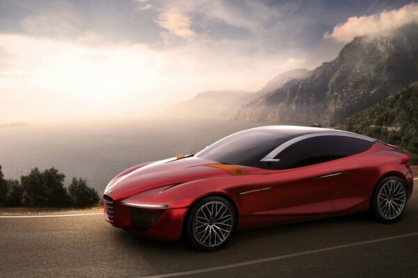 Ein rotes Alfa Romeo-Auto auf der Straße vor dem Hintergrund von Bergen, Himmel und Morgengrauen