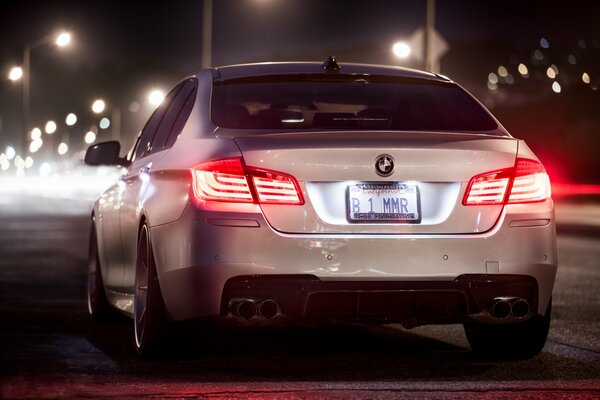 White BMW fifth series in the night