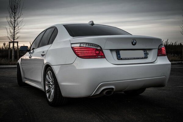 Rear view of a white BMW car on the street