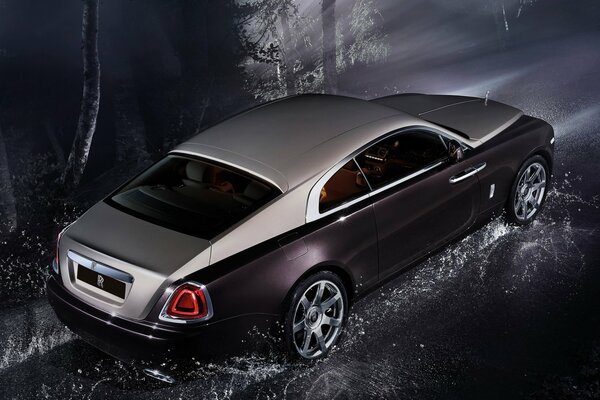 Coche Rolls-Royce sobre asfalto mojado