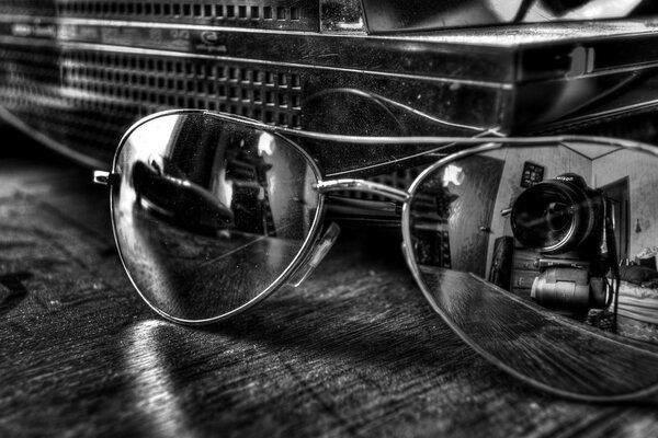 Reflection of the camera in glasses. Glasses on the table