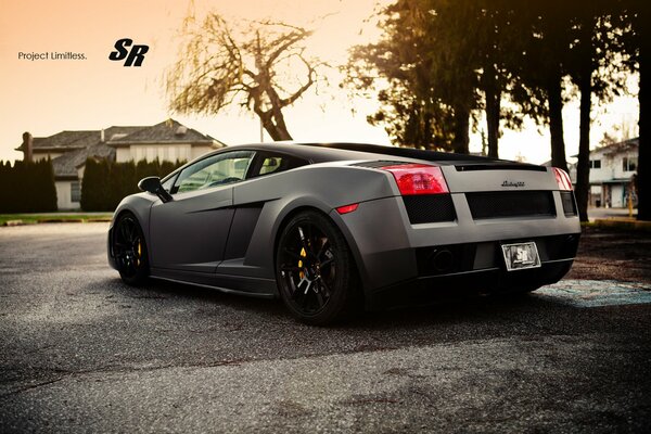 The back of a lamborghini car on the background of a house