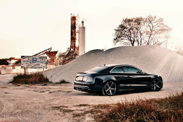 Audi s5 car on the background of an industrial landscape