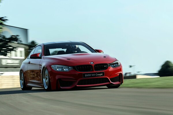 Czerwone Coupe bmw M4 na drodze