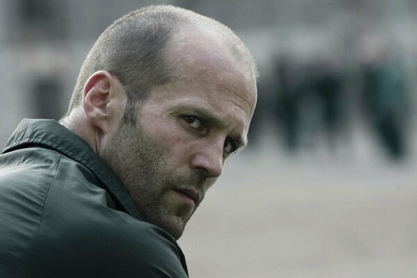 Portrait of Jason Statham looking back