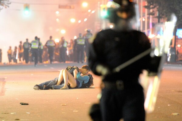 Passionate kiss, lovers embrace on the asphalt