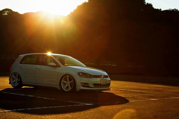 A white Volkswagen at a yellow sunset