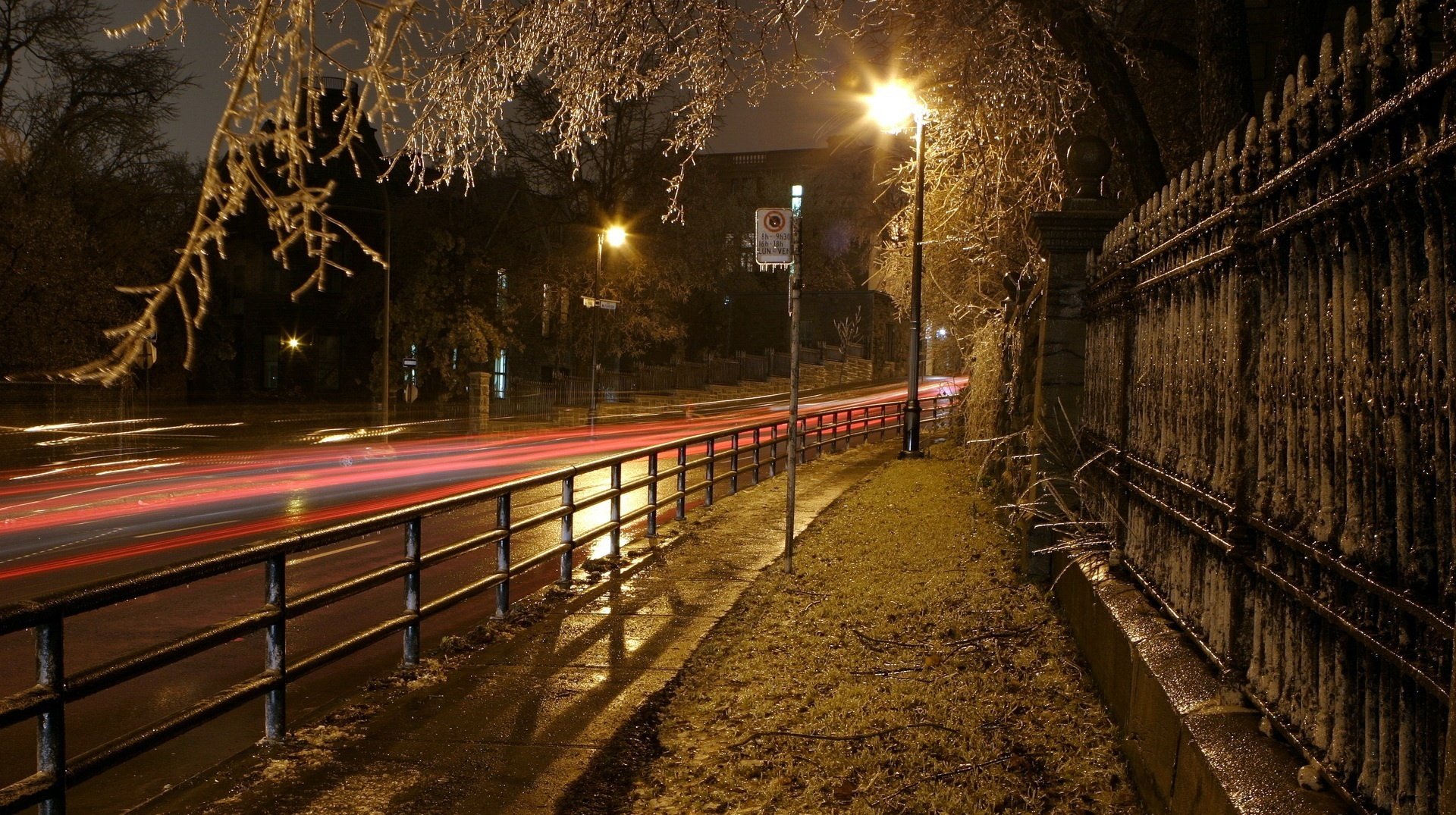 fence of antiquity red stripes city fence sidewalk evening lights lanterns bright light road