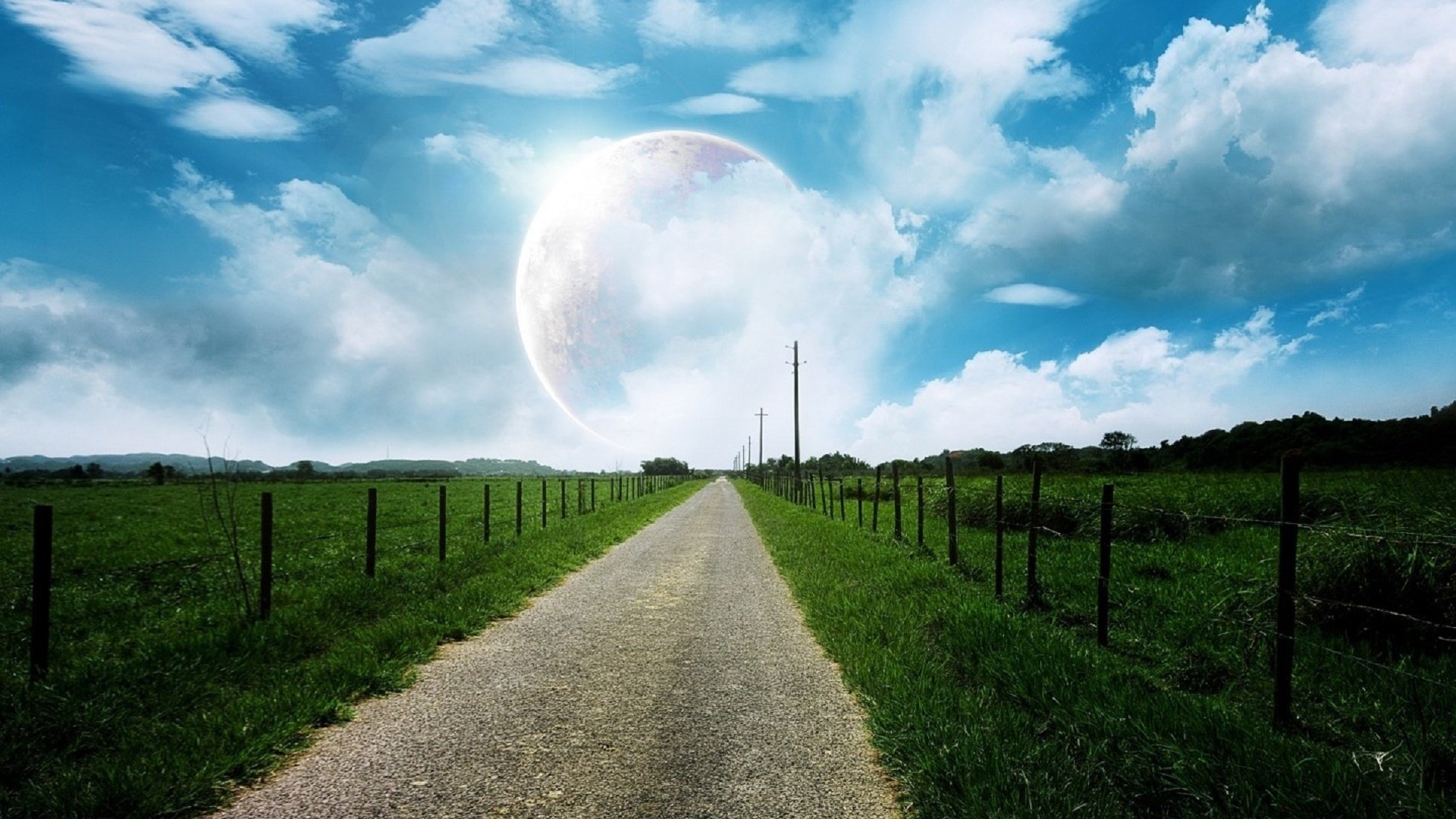 fence beside the road field grass road the sky the fence fence planet greens clouds nature landscape post