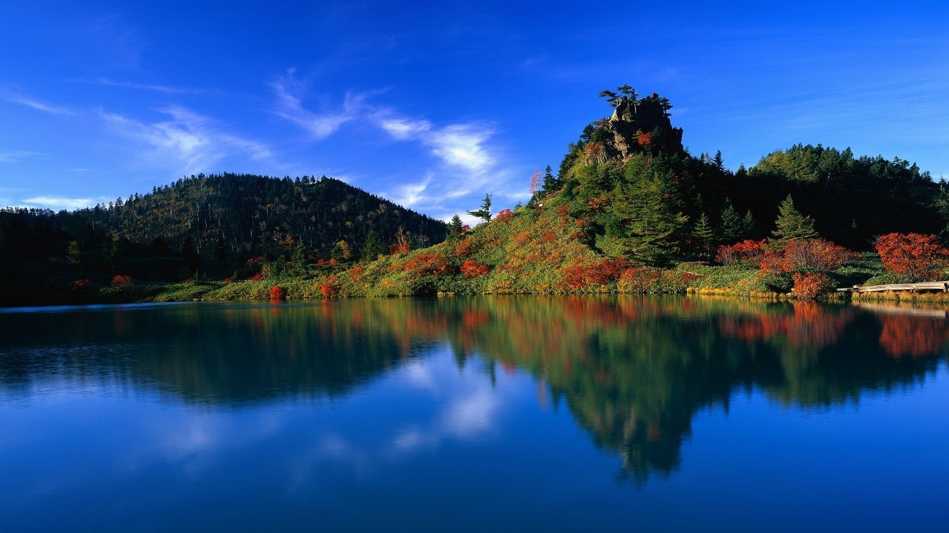 mountain hill red bushes water mountains the sky lake blue sky blue water reflection the colors of autumn landscape nature view surface