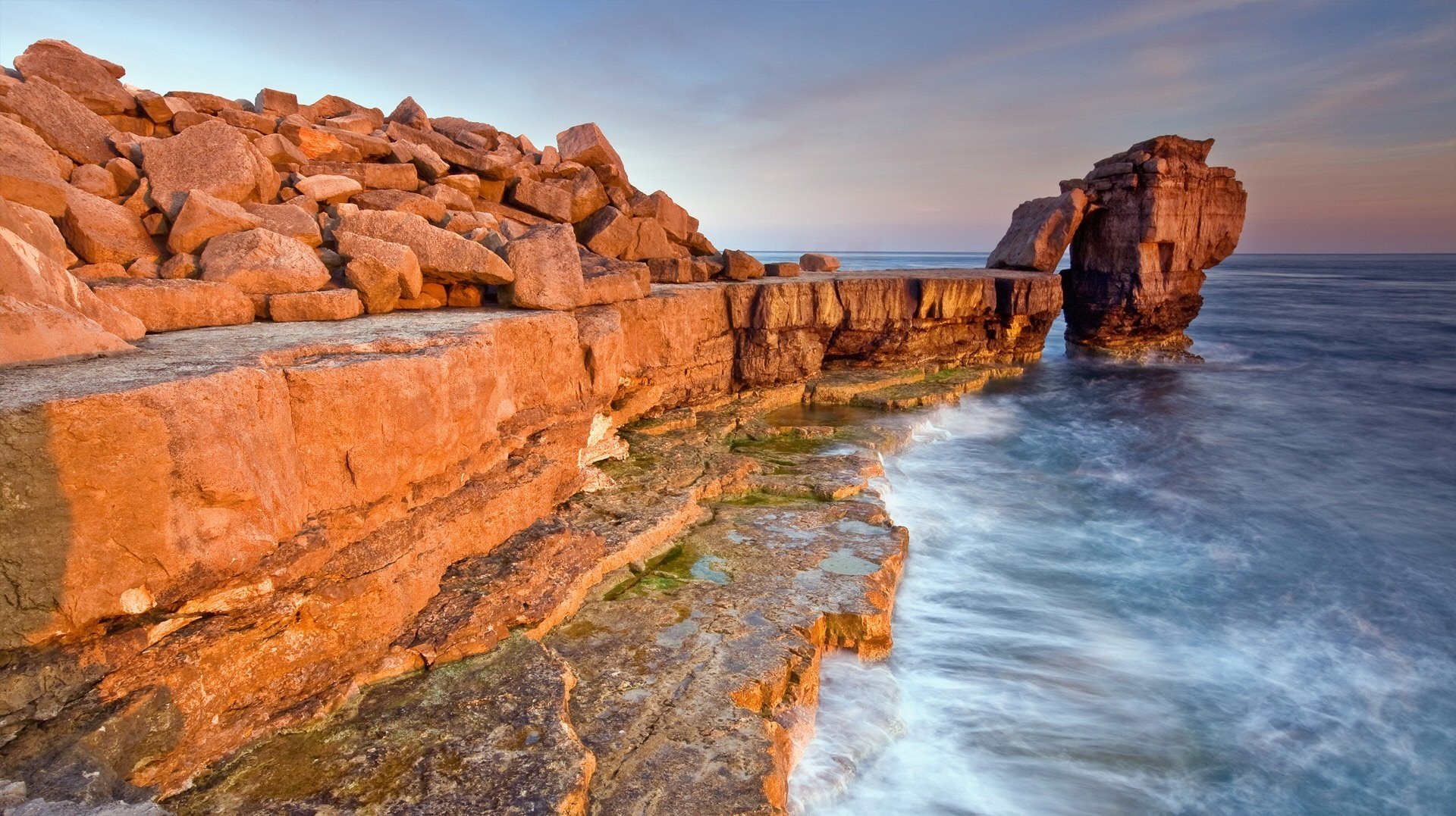 reddish stones surf the wave stones sea landscape water shore