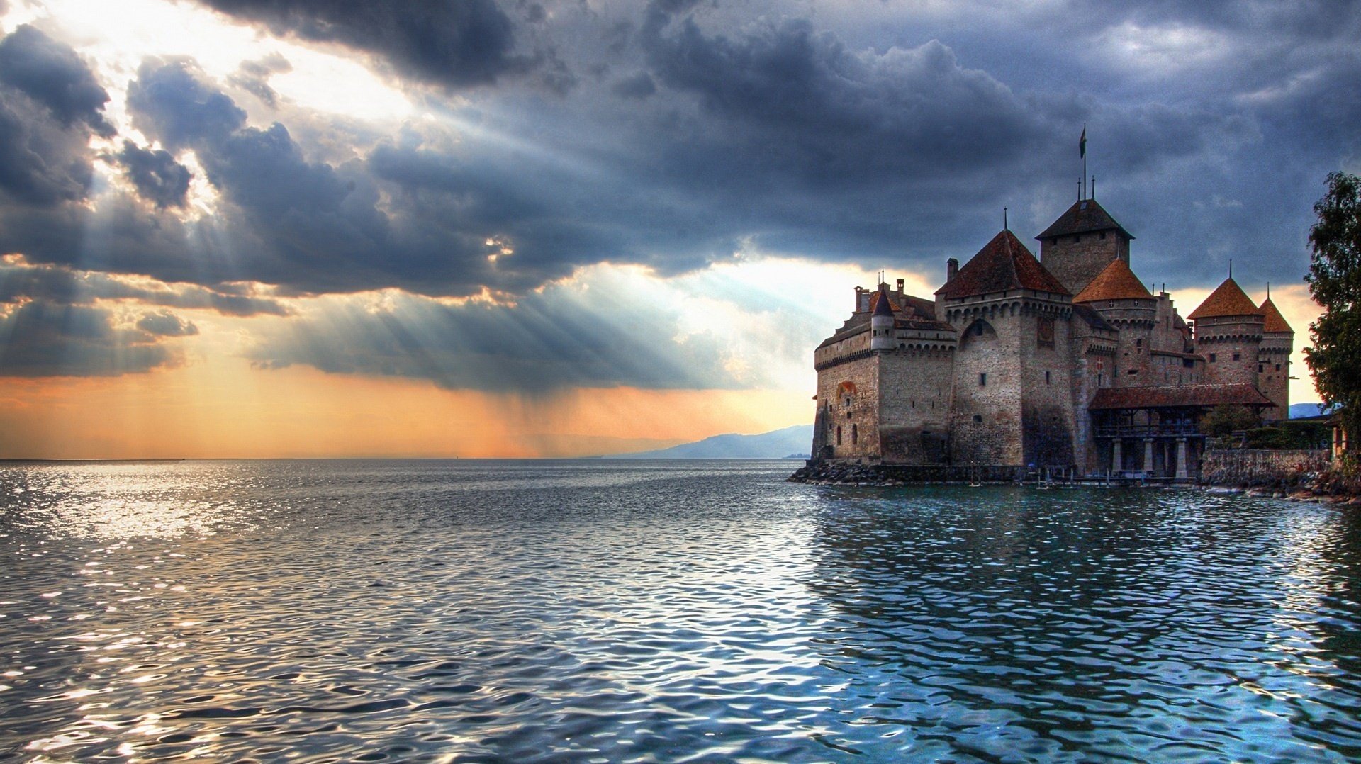 tone castle water spaces the ancient structure sunset water rays sea space nature landscape fortress clouds horizon