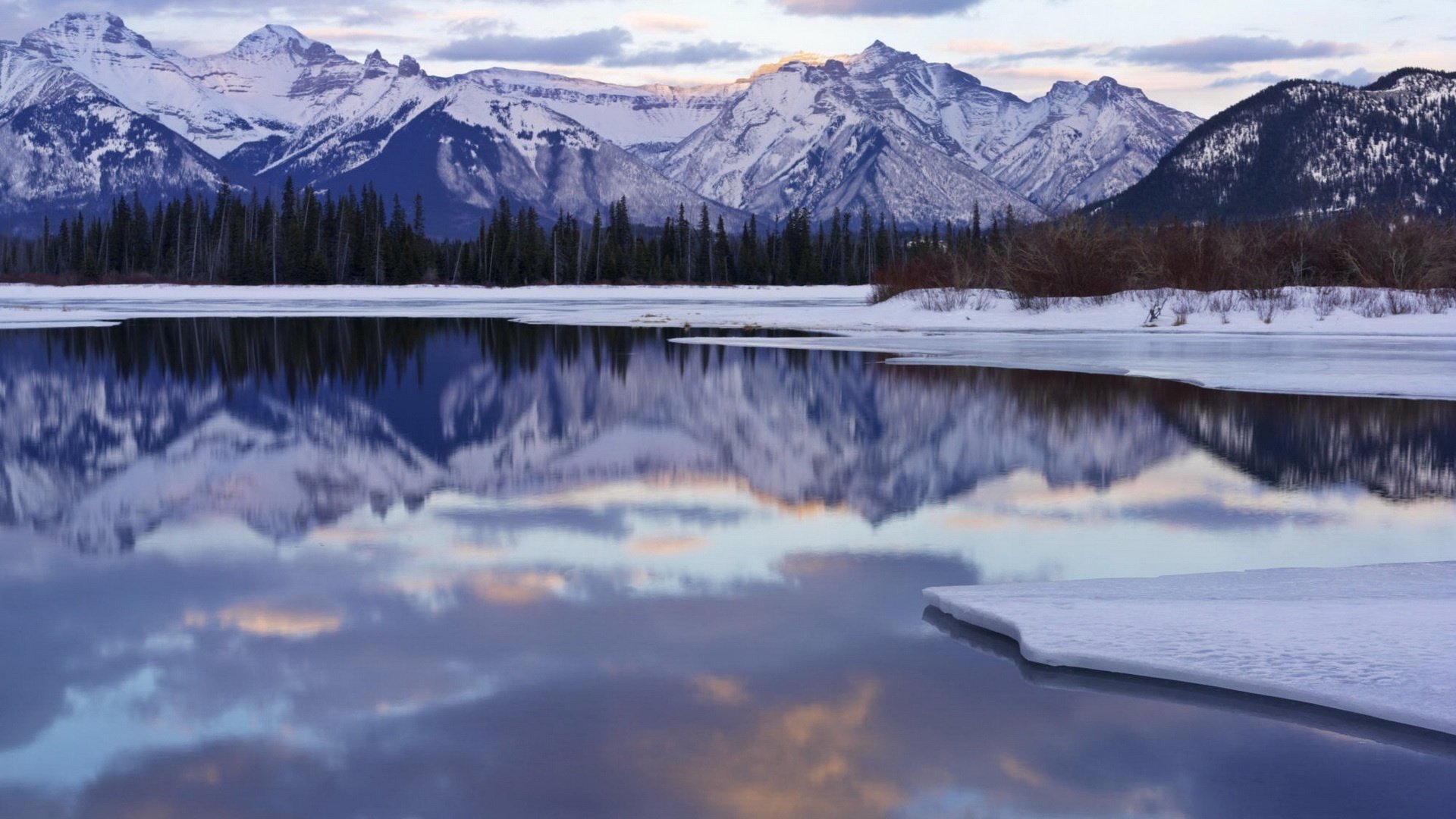 now pilena winter time mountains ice winter water lake surface peaks sky clouds frost reflection snow