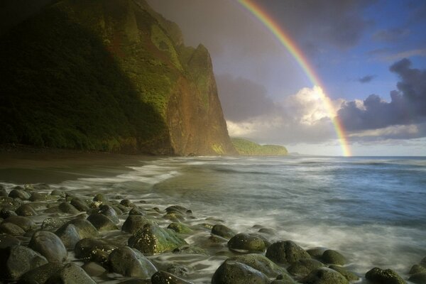 Rainbow going into the sea surf