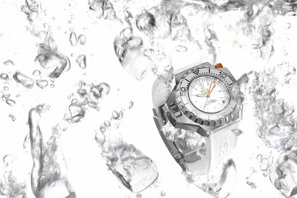 Omega watch on a white background among a cloud of ice in the water