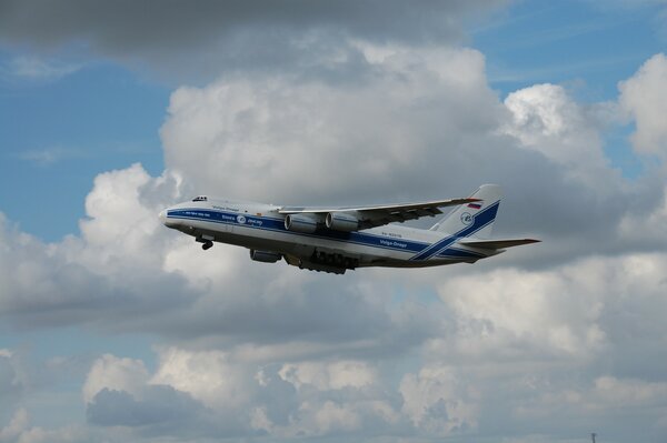 Military transport plane on the background of white clouds