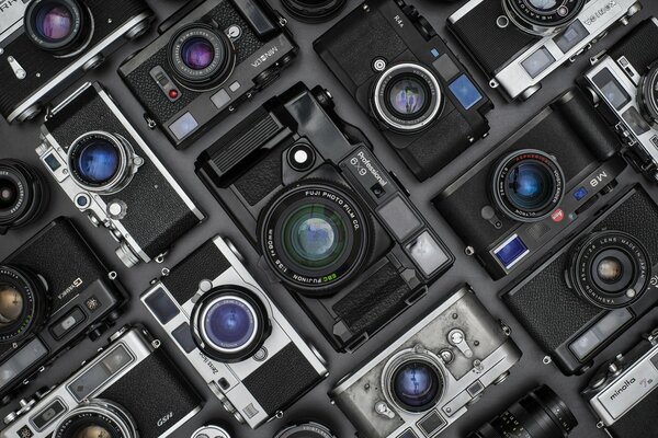 A large number of cameras stacked together in a case