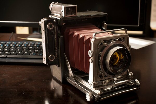 Antique camera on the computer desk