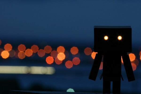 Wooden man on the background of lights