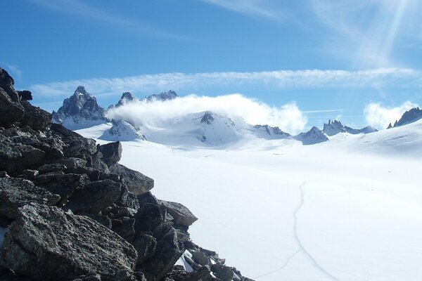 Grey mountain rocks covered with snow