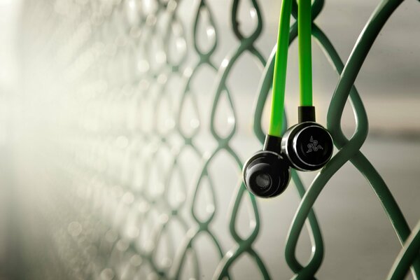 Black headphones with green wire hanging