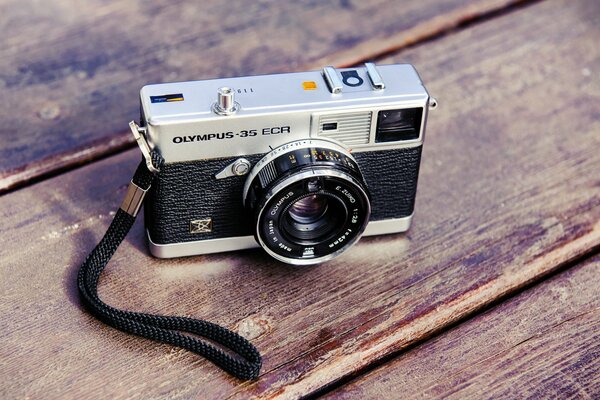 Camera in shooting mode on a wooden table