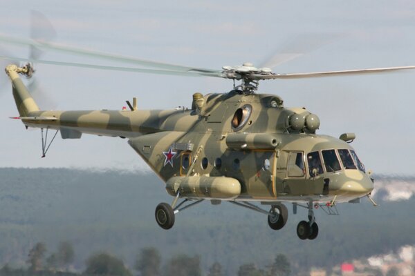 The Mi-8 helicopter is flying high in the sky