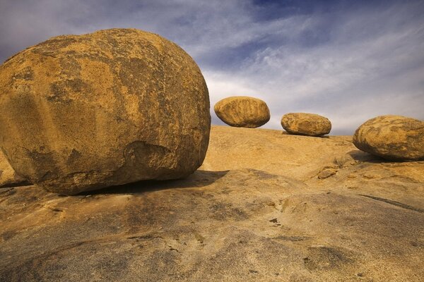 Rounded beige boulders on the slope