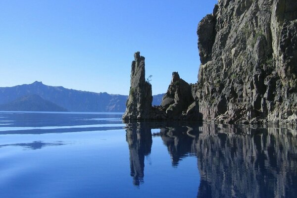 Rocks on the background of mountains lake surface