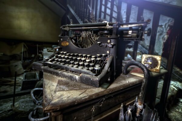 An old rare typewriter with a clock on the background of the stairs