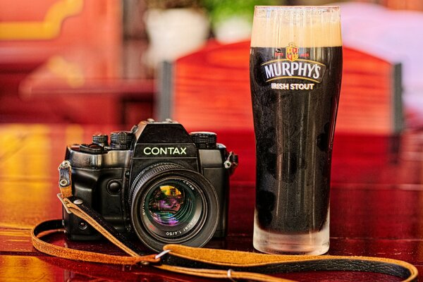 Camera on the table with a glass of beer