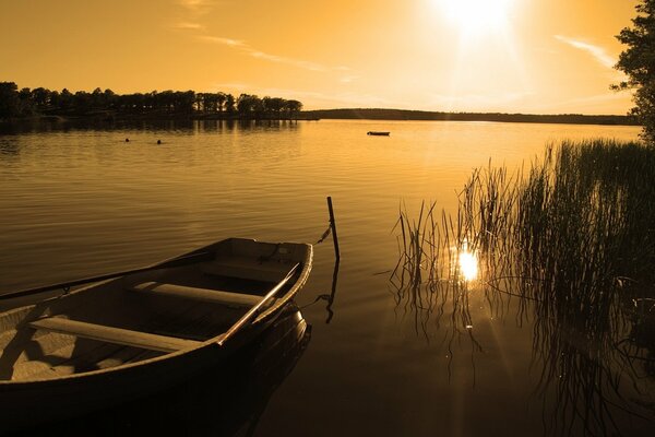 A boat in kamash on the background of the setting sun