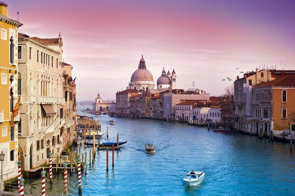 In the city of Venice, a boat sails along the canal