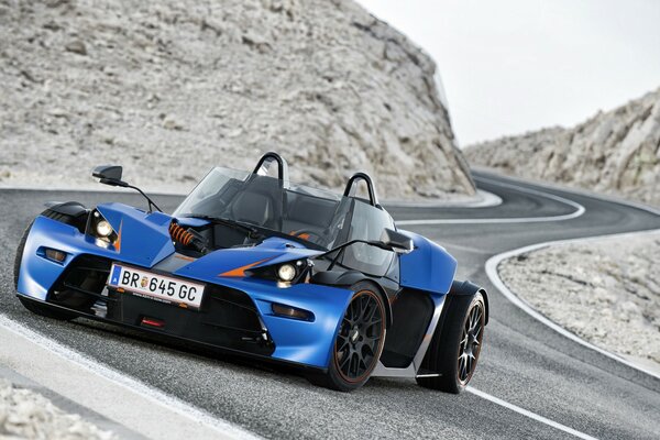 Blue fast sports car of 2013 on a steep road