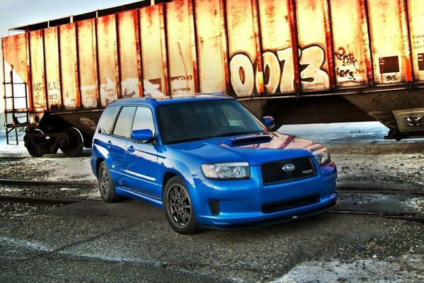 Stylish Subaru crossover in pursuit of the train