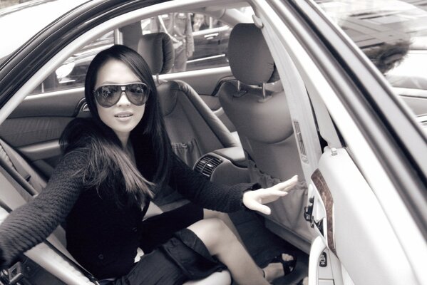 A girl sitting in the back seat of a car