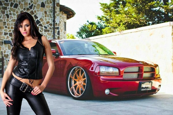 Beautiful girl next to a red car