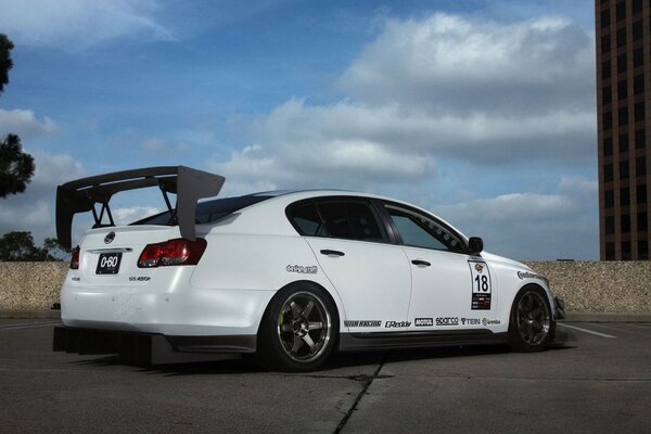 Tuned Lexus sedan in white against the sky