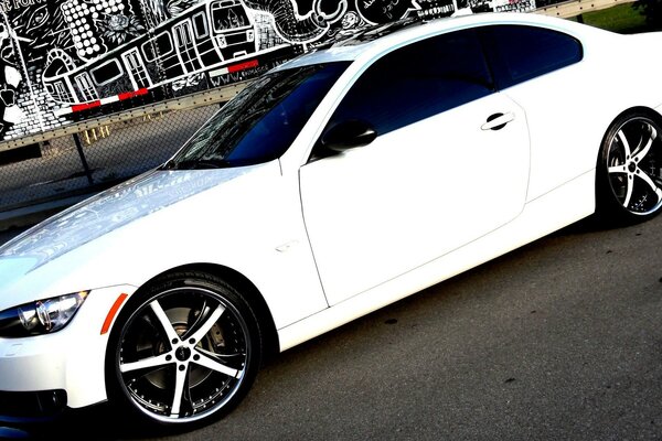 White bmw coupe on an asphalt road