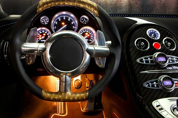 The side of the car and gilding on the steering wheel