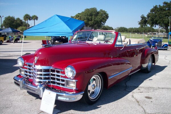 Red retro car at the exhibition with an open top