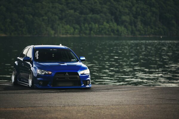 Blue Mitsubishi on the lake shore