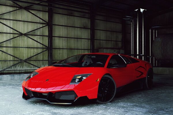 Une Lamborghini rouge se tient dans un hangar