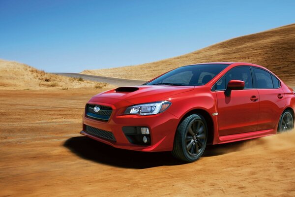 A red Subaru car rushes along the road