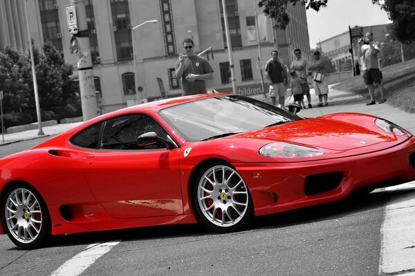 Red Ferrari car on black and white background